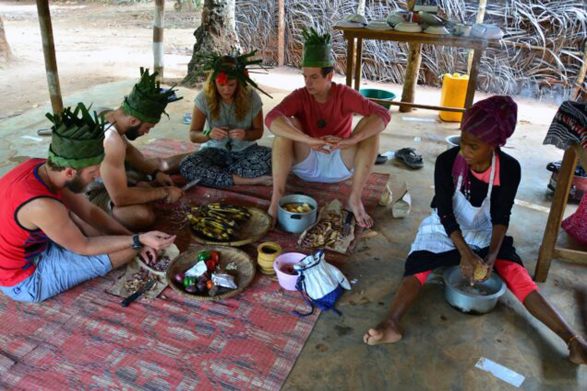 Participants enjoying a hands-on Zanzibar cooking class, learning to prepare Swahili dishes.